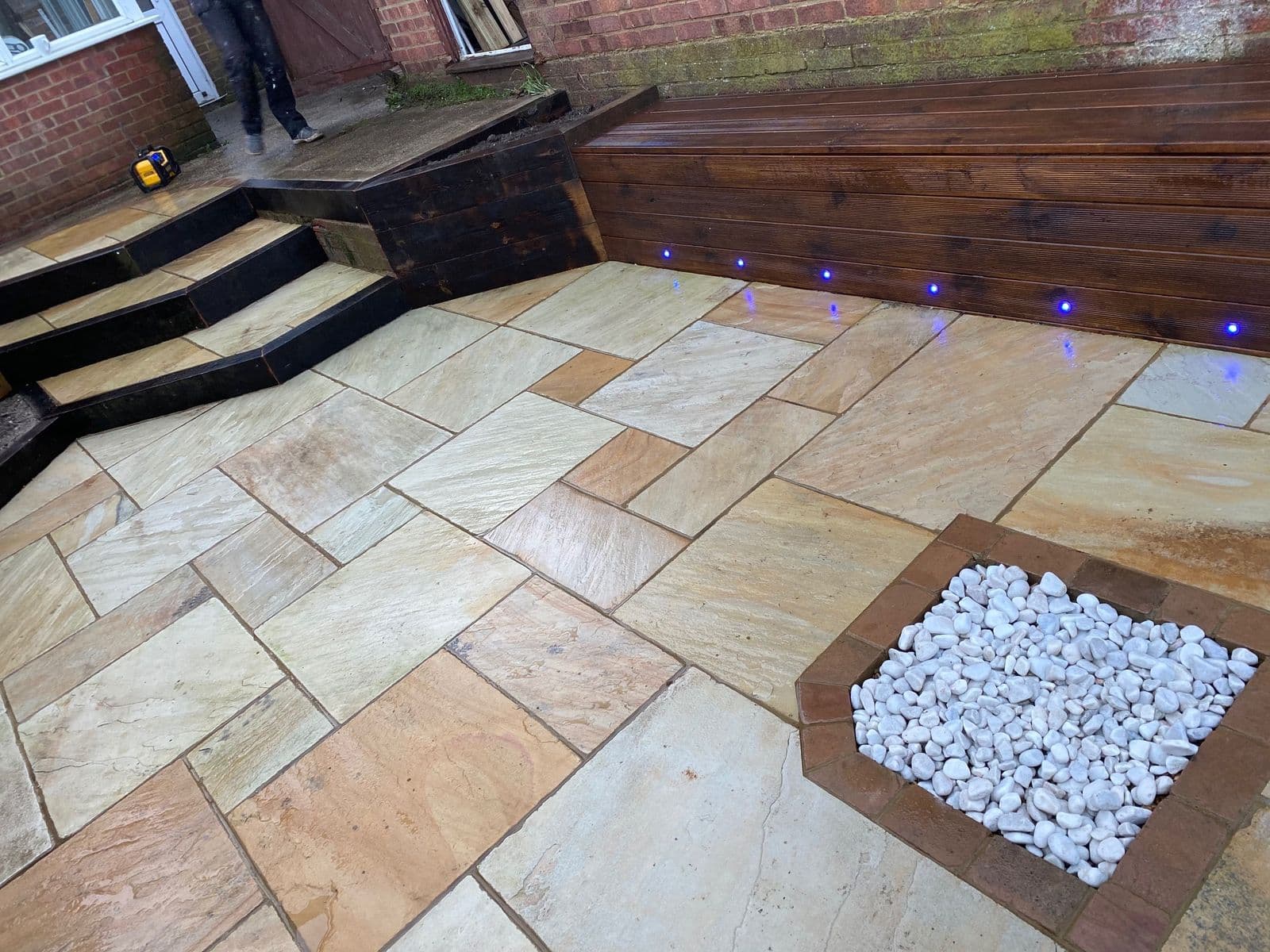 Sandstone patio with lit seating